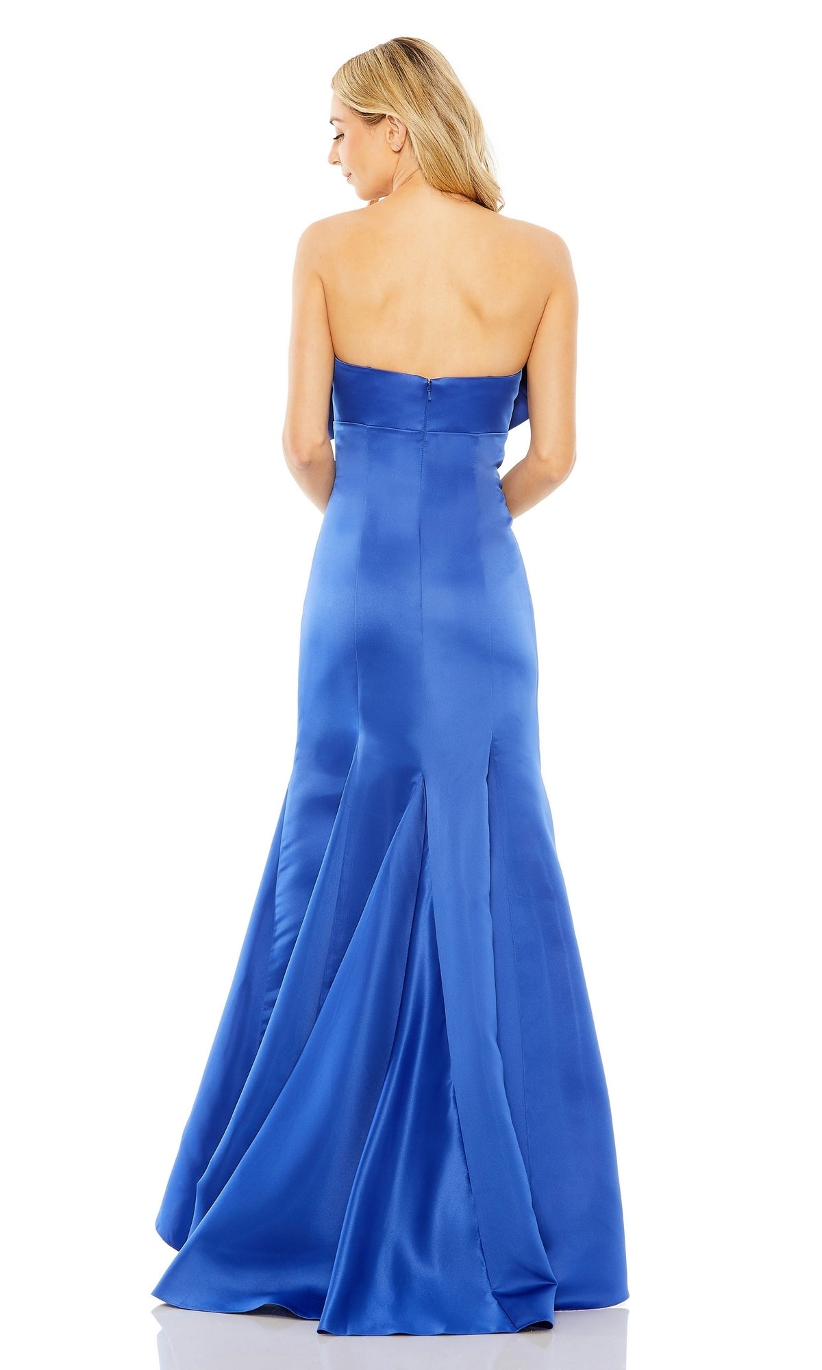 A woman with blond hair models the Mac Duggal 49701 Strapless Mermaid Formal Dress, featuring a fitted bodice and flared blue satin floor-length skirt, shown from the back.